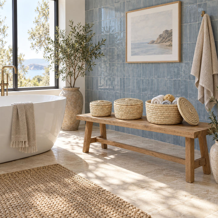 Three palm-leaf baskets on a wooden bench in the bathroom, the largest one holding towels: 3.5 liters, 7 liters, and 15 liters in volume.