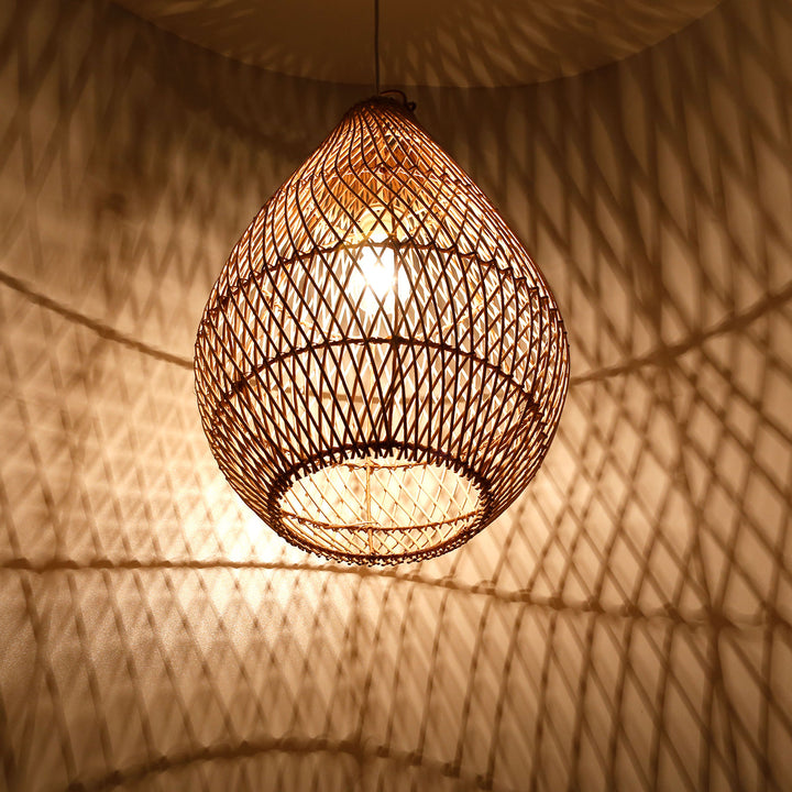Drop-shaped ceiling light made of hand-woven rattan with warm light and decorative shadow play