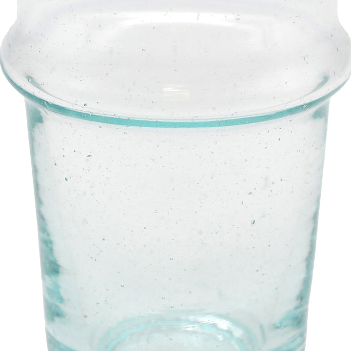 Iced coffee in a transparent glass - handcrafted surface with structure