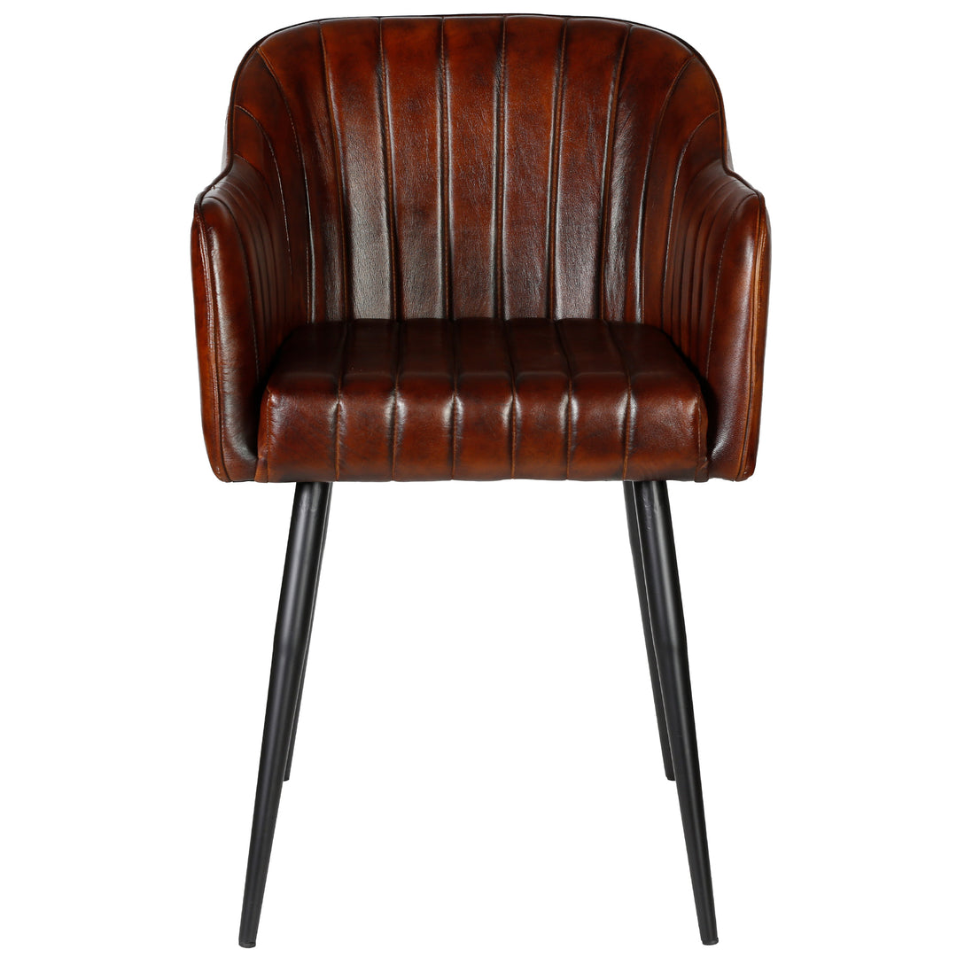 Front view of an antique brown leather armchair with vertical quilting, armrests and a black metal frame - elegant chair for the dining room or living room.