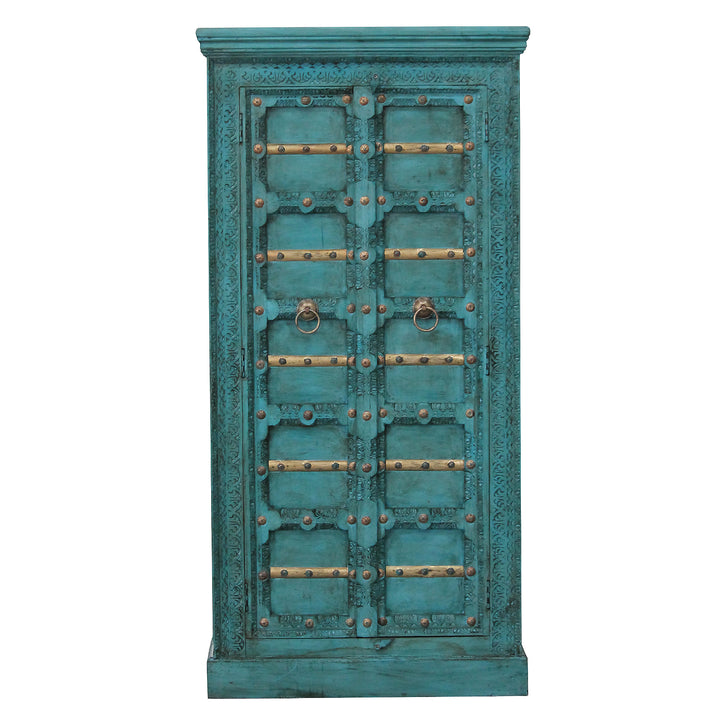 Front view of the turquoise mango wood cabinet, showing carved ornaments, gold-coloured trim and two doors.