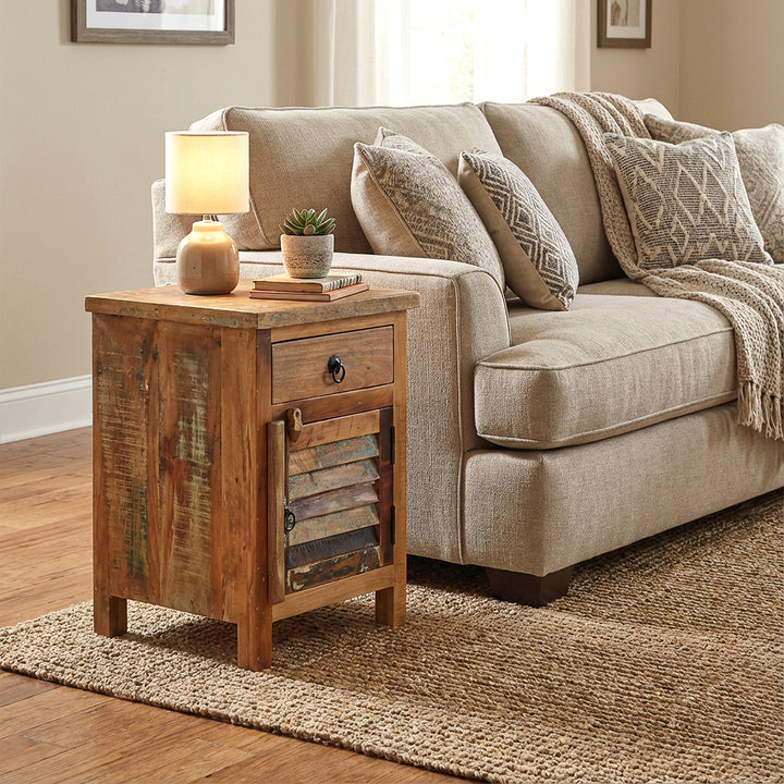 Solid wood chest of drawers as a side table next to the sofa, homely scene with warm light