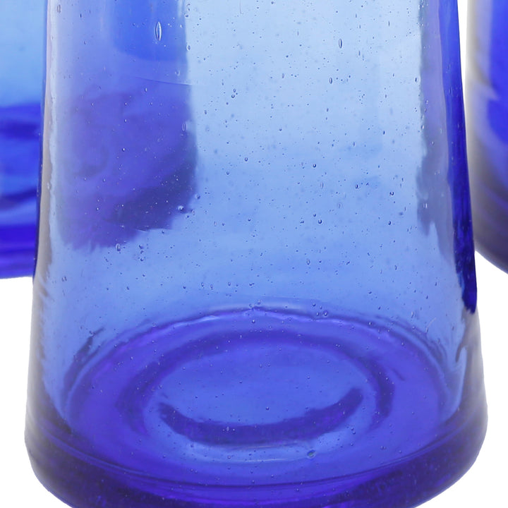 Four long drink glasses made of blue recycled glass - conical, heavy and handmade