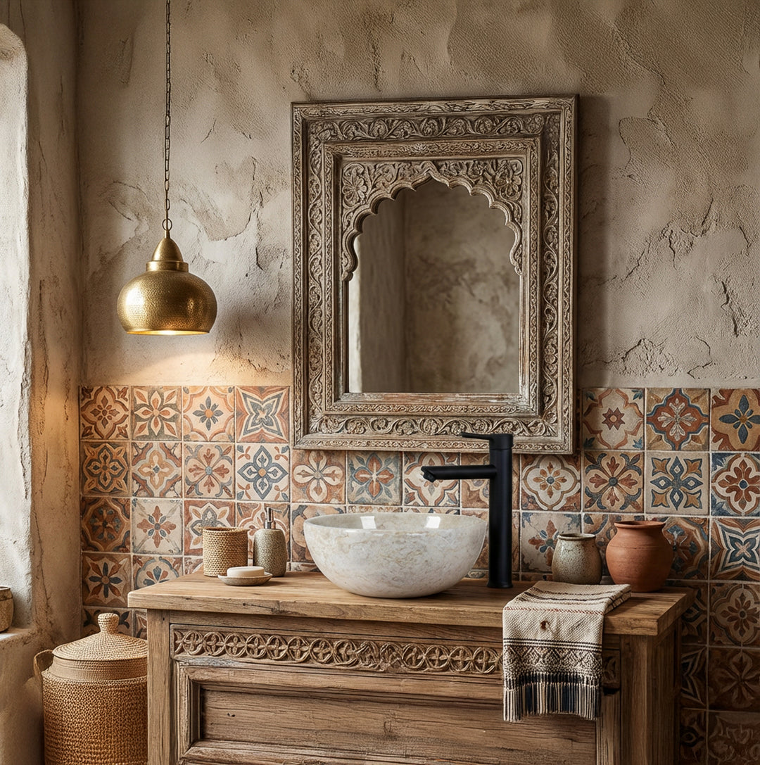 Round natural stoneWashbasin as an attachment on a wooden washbasin with a black fitting in front of patterned tiles in an oriental bathroom ambience