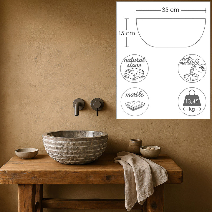 Round Washbasin Made of natural stone with dimensional graphics, staged on a wooden console, calm bathroom ambience in warm earth tones