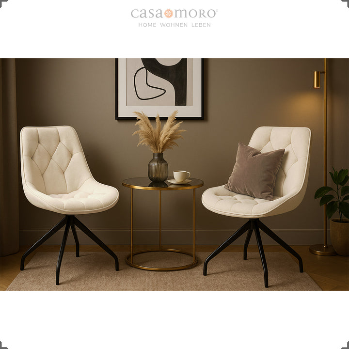 Two upholstered chairs that can be rotated 360° in beige with a black metal frame - a cozy seating area with a side table and wall art in the modern living room