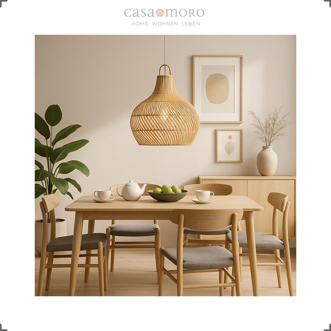 Rattan lamp above a dining table in the bright dining room, handmade and with a soft play of light