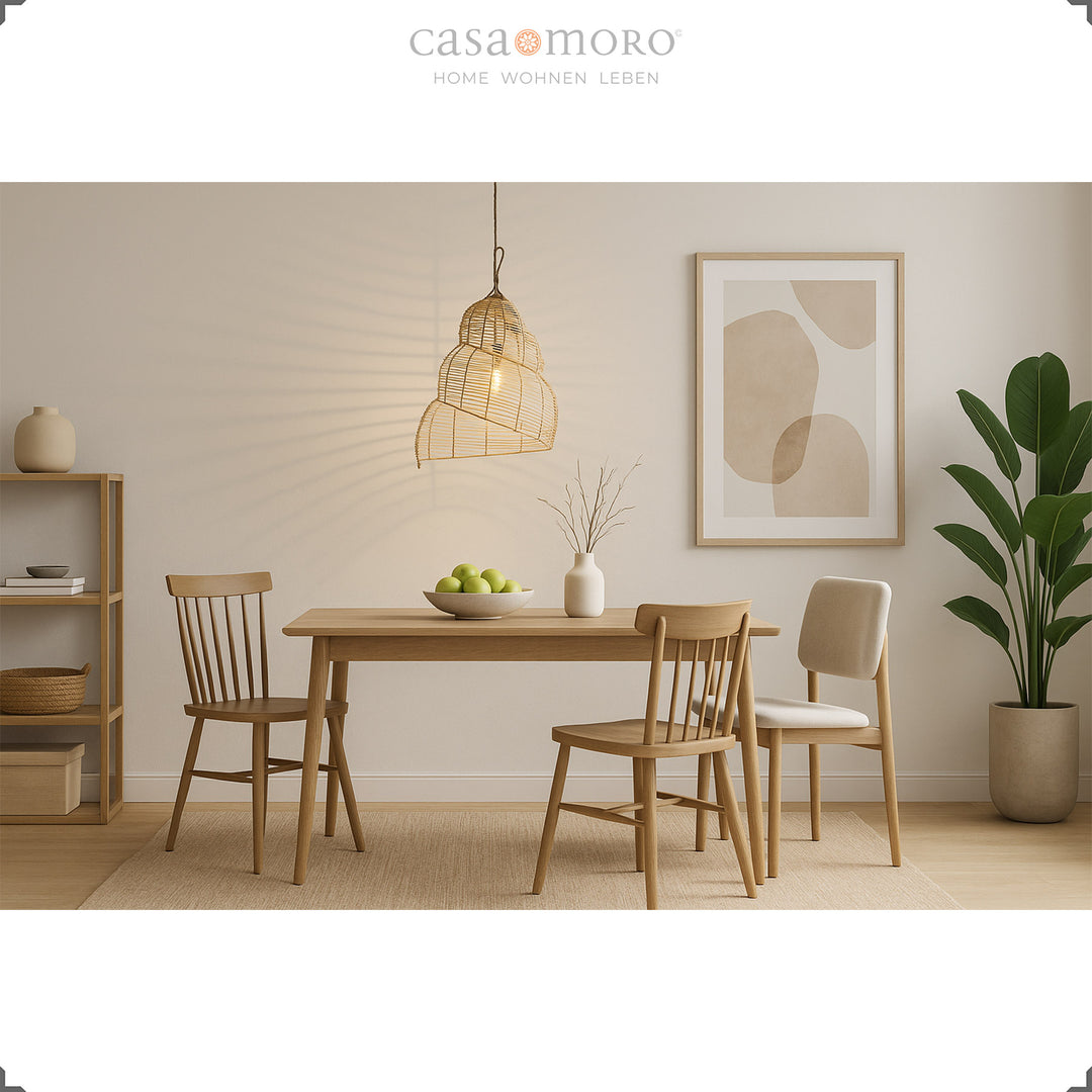 Hanging rattan lamp above a dining table in the modern dining room creates a warm play of light and shadow