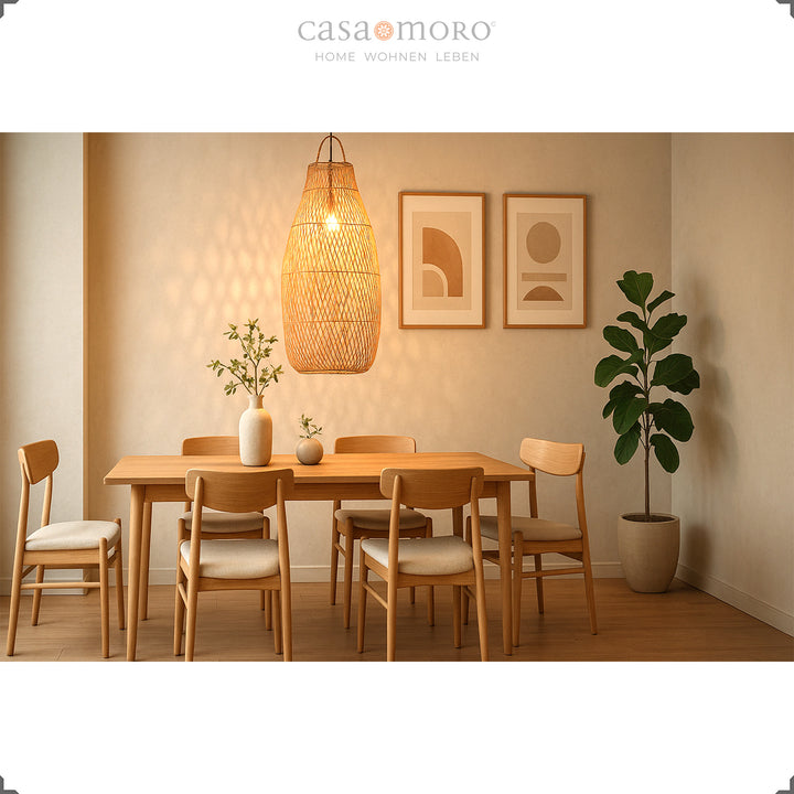 Tall rattan lamp above dining table in modern dining room, warm light and natural furnishings