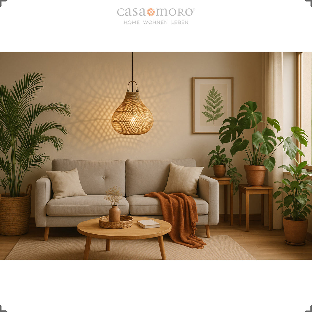 Rattan lamp above sofa in modern living room with plants and warm lighting ambience