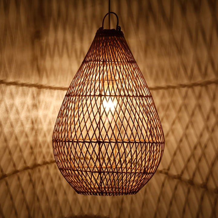Teardrop-shaped lampshade made of hand-woven rattan with fine weave and warm play of light