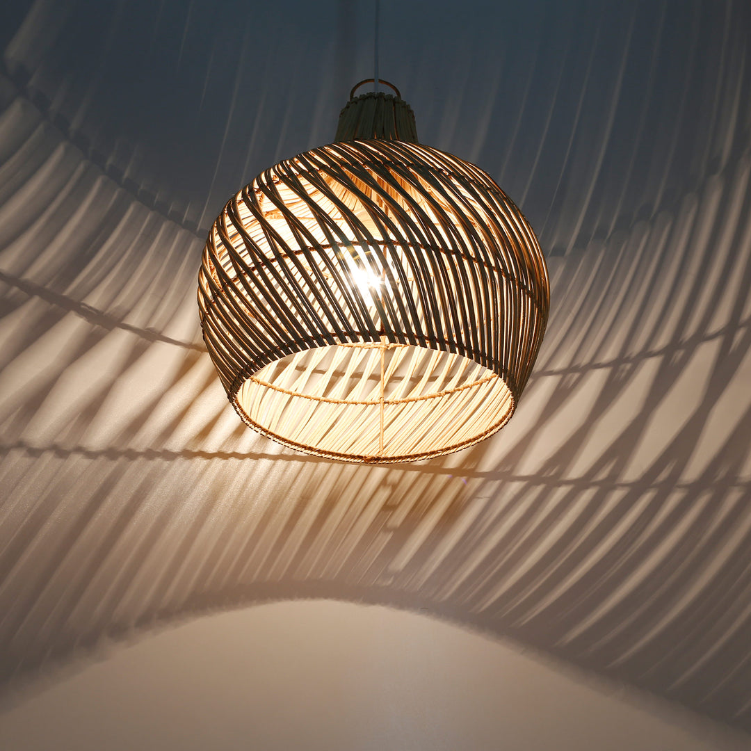 Illuminated rattan lampshade with open weave and impressive play of light and shadow on the wall and ceiling