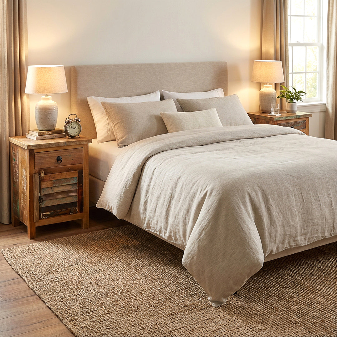 Solid wood chests of drawers as bedside tables in the bedroom, light textiles, warm light