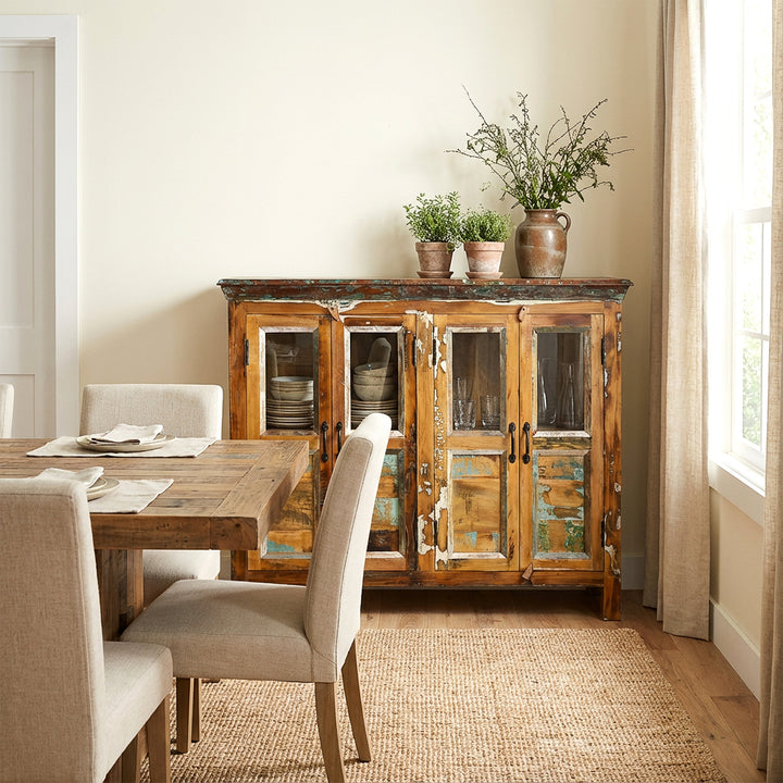 Solid wood sideboard with glass doors in the dining room as storage space for dishes and glasses
