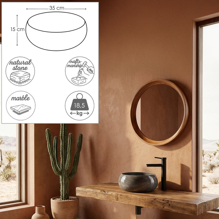 Round stone washbasin made of natural stone on a wooden console in the warm bathroom with black fittings and integrated dimensional graphics