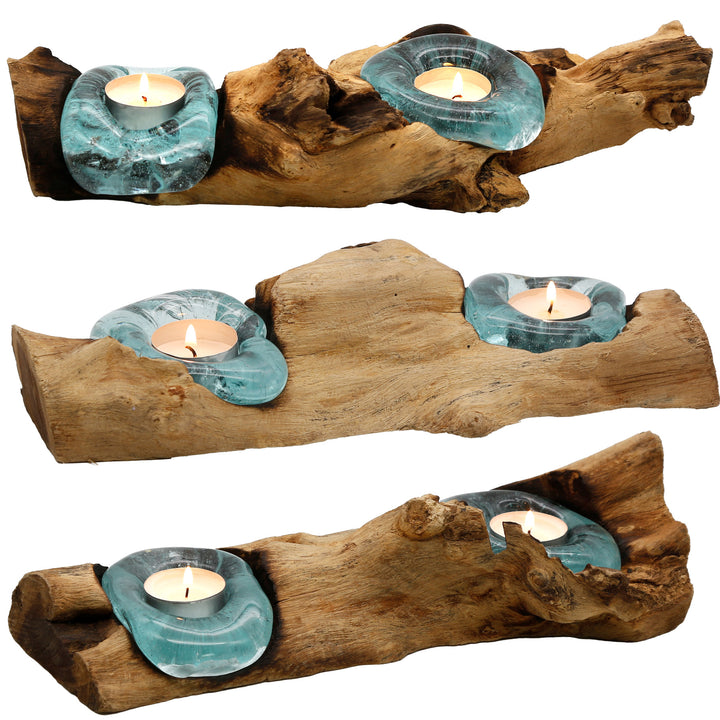 Elongated tea light holders made of glass and root wood in three versions, each with its own shape and warmly glowing tea light