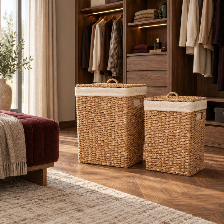 Two seagrass laundry baskets with capacities of 50 and 90 liters and closed lids, placed in front of a wooden cabinet in the dressing room.