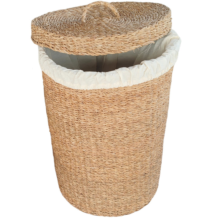 A woven seagrass laundry basket with a 75-liter capacity, a light-colored fabric lining, and a slanted lid.